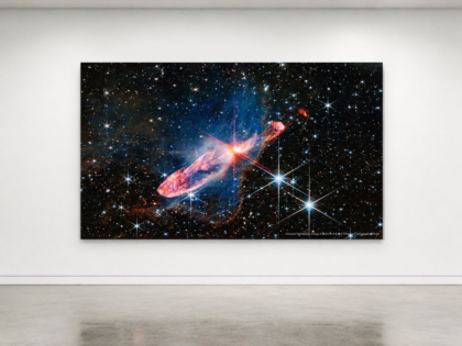 Herbig-Haro 46/47 36 x 60 glossy aluminum print shown to scale in a white gallery bench